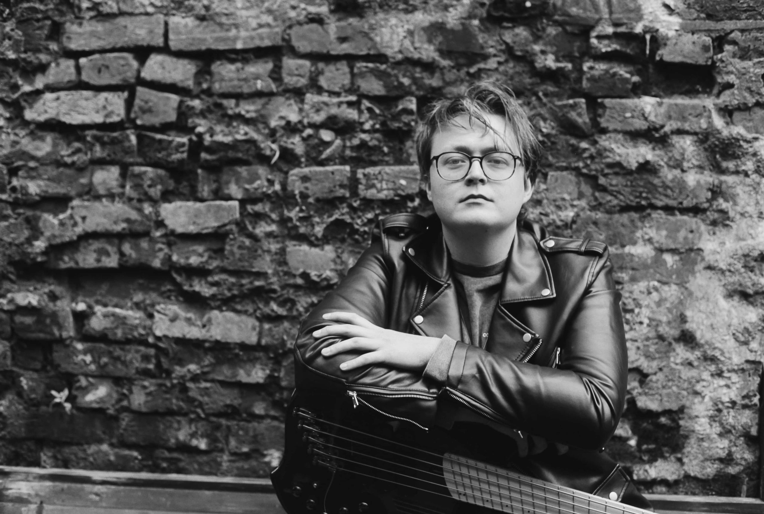 musician-with-guitar-black-and-white-outdoor-photo