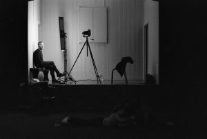 man-and-camera-on-stage-black-white