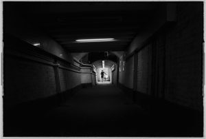 boy-on-bike-tunnel-black-and-white-old-style-photo